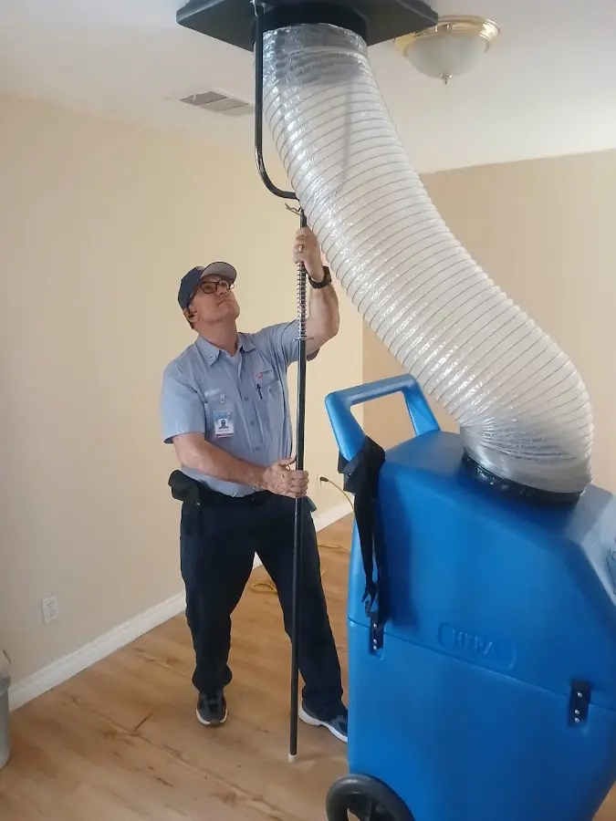 HVAC Installation technician using HEPA equipment in Wall